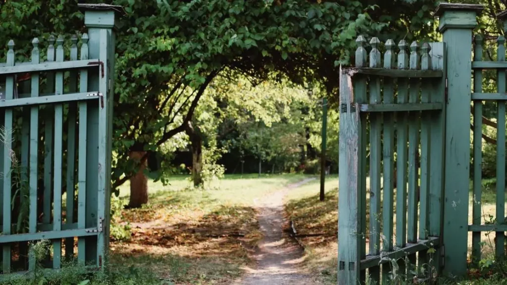Green gate opens to a peaceful countryside path for a benefits of forgiveness Bible study